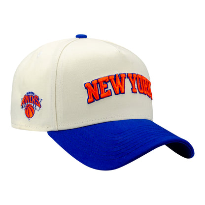 New Era Knicks New York Wordmark Two-Tone Chrome/Royal 940 A-Frame Snapback In White - Front Right View